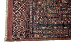 A vintage Pakistani Princess Bokhara rug featuring a geometric diamond pattern in red and black.