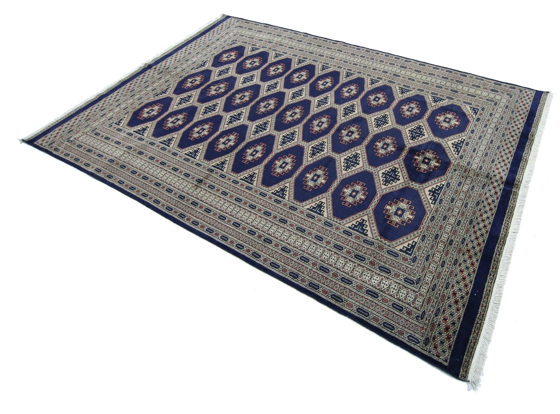 A vintage Pakistani Princess Bokhara rug featuring a repeating geometric pattern on a blue field.