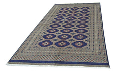 A vintage Pakistani Princess Bokhara rug featuring a repeating diamond pattern in deep blue.