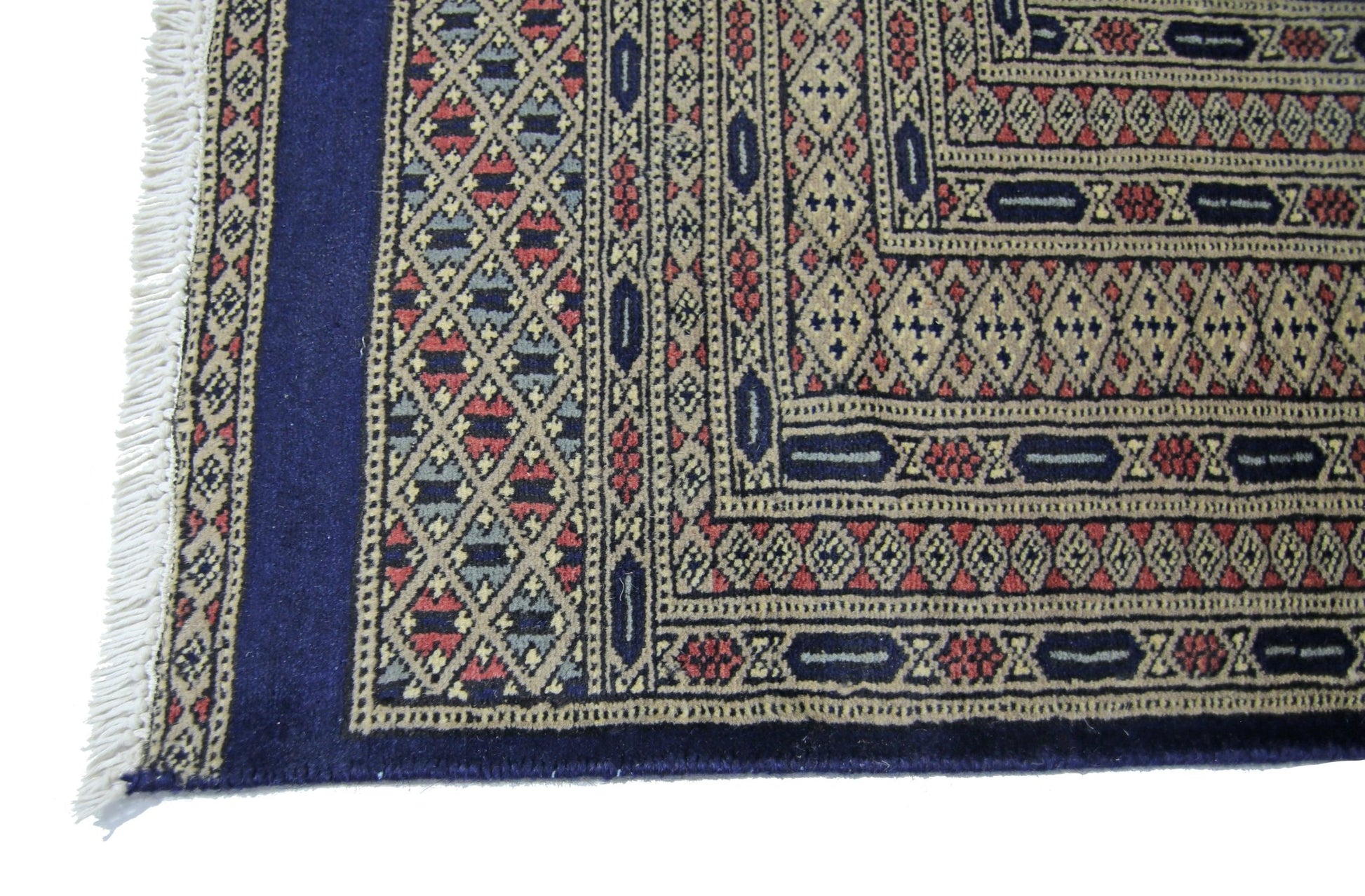 A vintage Pakistani Princess Bokhara rug featuring intricate geometric patterns in red and blue.