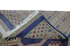 A vintage Pakistani Princess Bokhara rug featuring a geometric pattern in blue, red, and beige.