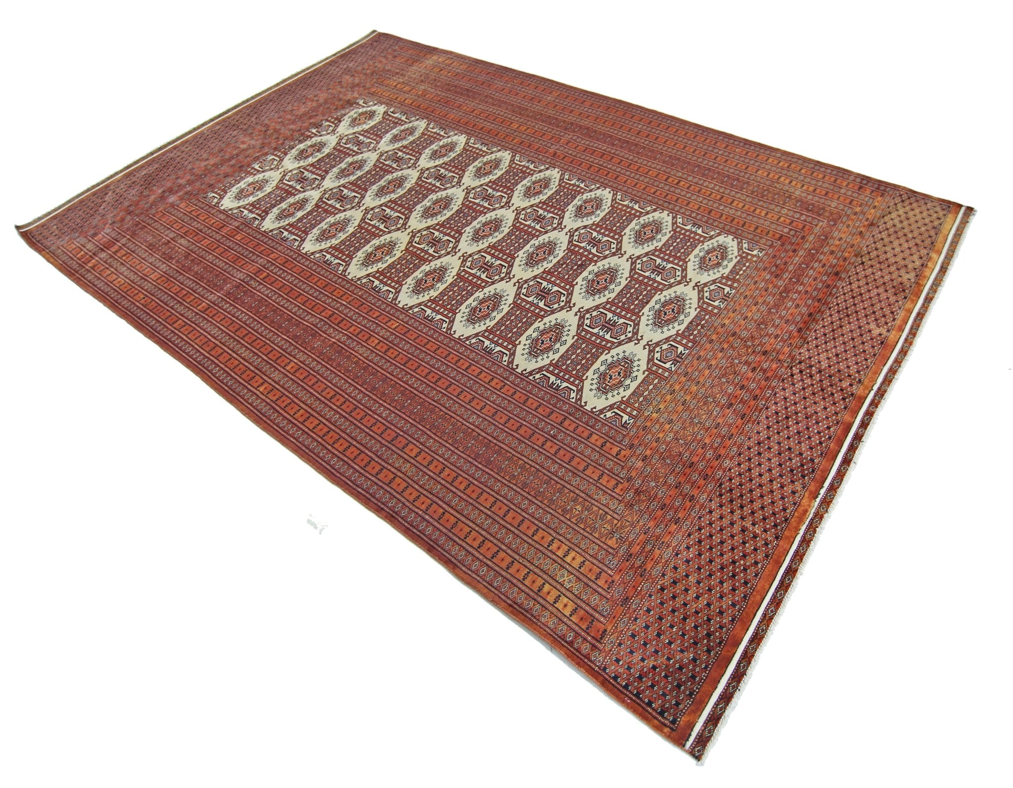 A vintage Pakistani Princess Bokhara rug featuring a repeating geometric pattern in red and cream.