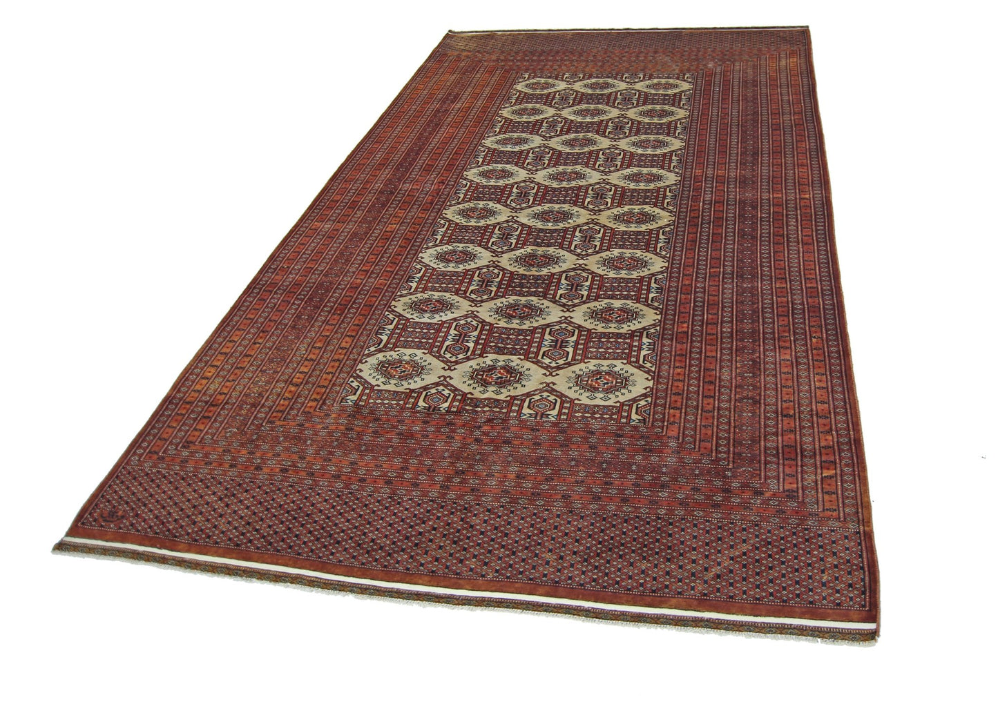 A vintage Pakistani Princess Bokhara rug featuring a repeating octagonal pattern in red and cream.