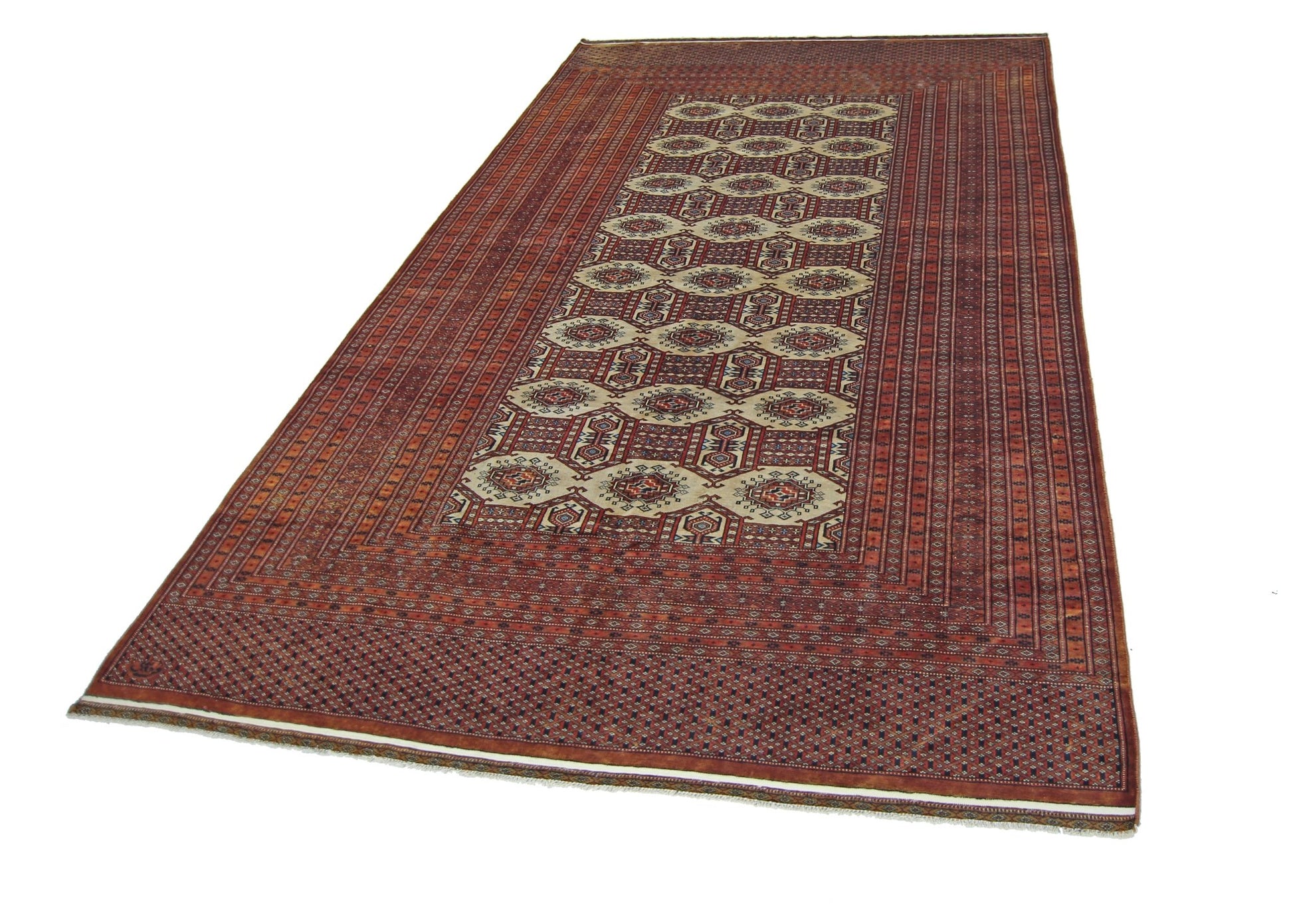 A vintage Pakistani Princess Bokhara rug featuring a repeating octagonal pattern in red and cream.