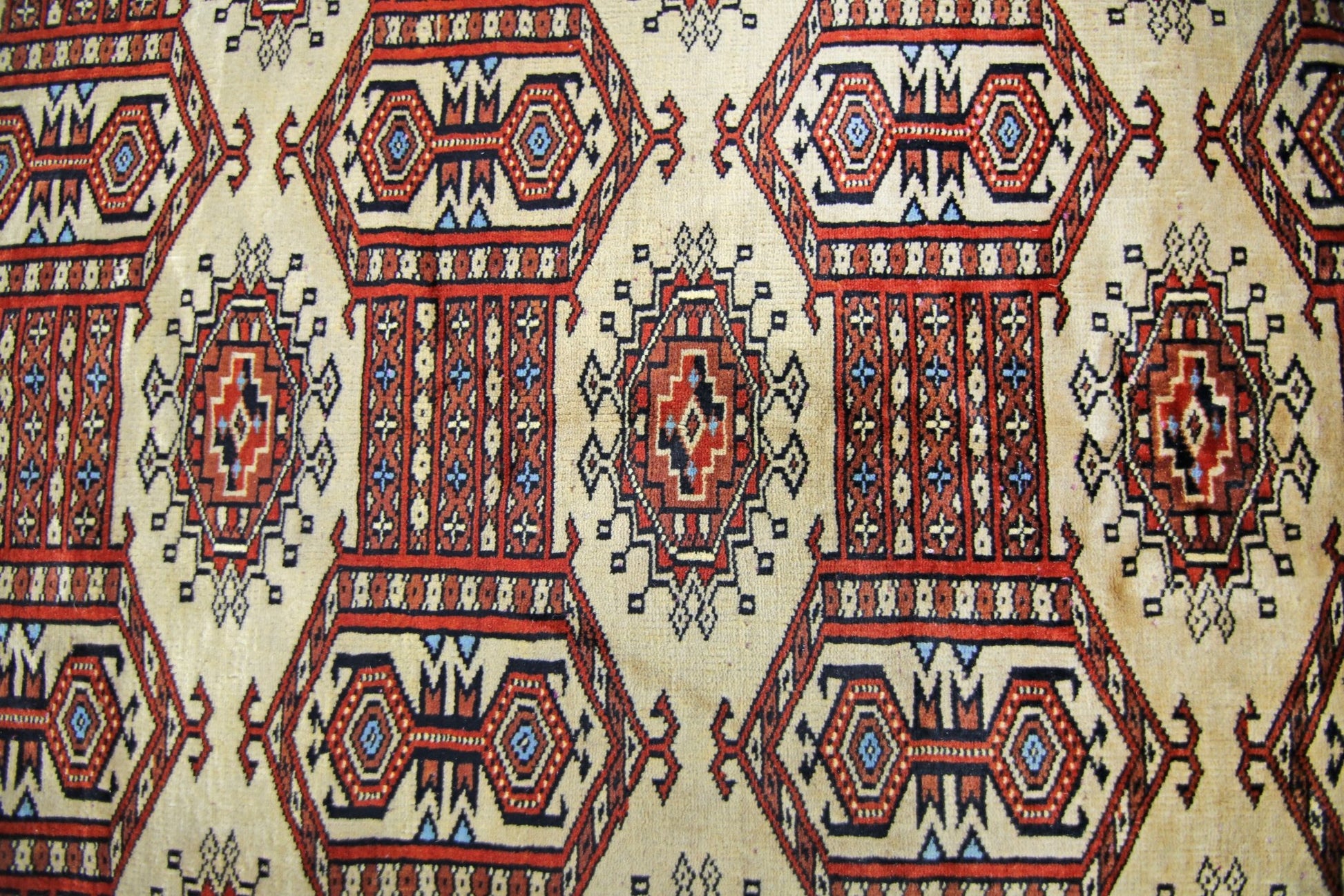 Vintage Pakistani Princess Bokhara rug featuring a repeating geometric pattern in red and cream.