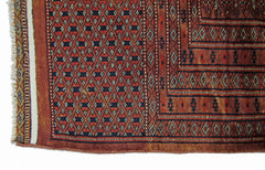 A vintage Pakistani Princess Bokhara rug featuring a geometric diamond pattern in red and black.