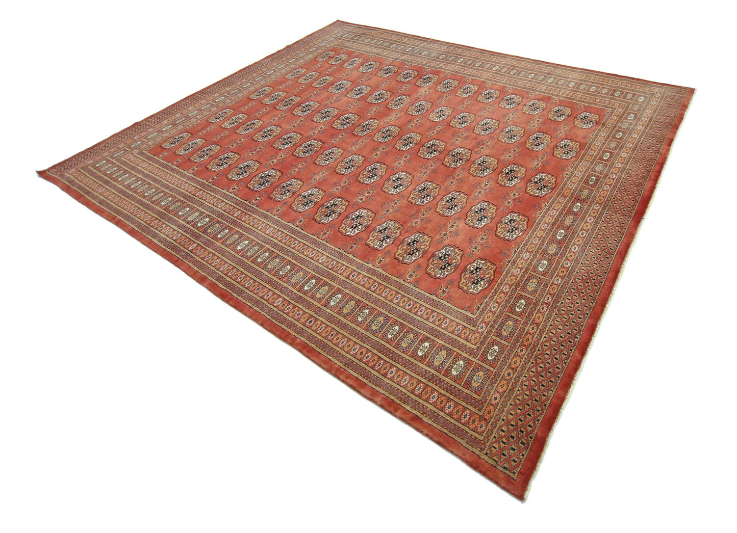 A vintage Pakistani Princess Bokhara rug featuring a repeating geometric pattern on a red field.