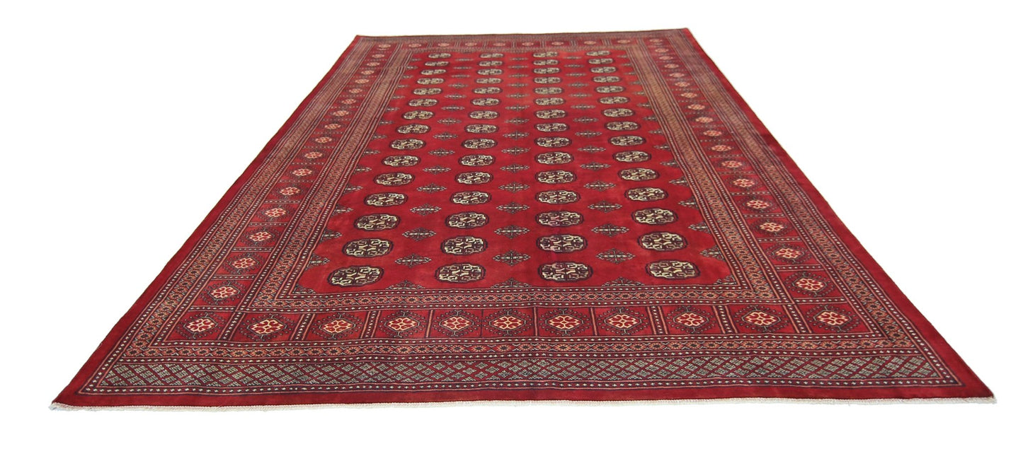 A vintage Pakistani Princess Bokhara rug featuring a repeating geometric pattern in deep red.