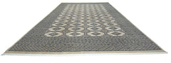 A vintage Pakistani Princess Bokhara rug featuring a repeating geometric pattern in wool.