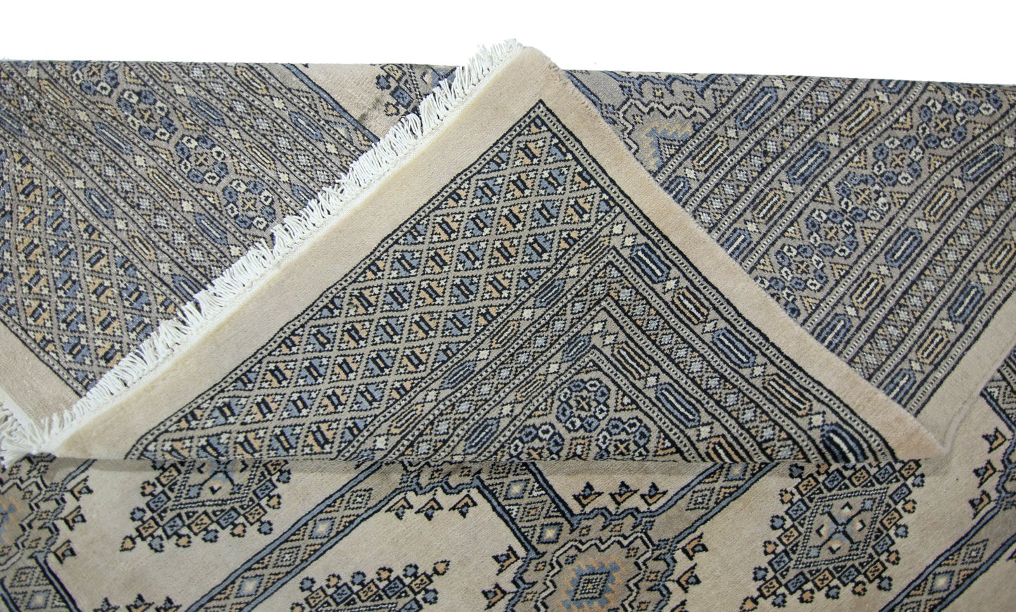 A vintage Pakistani Princess Bokhara rug with a geometric pattern in blue and beige tones.