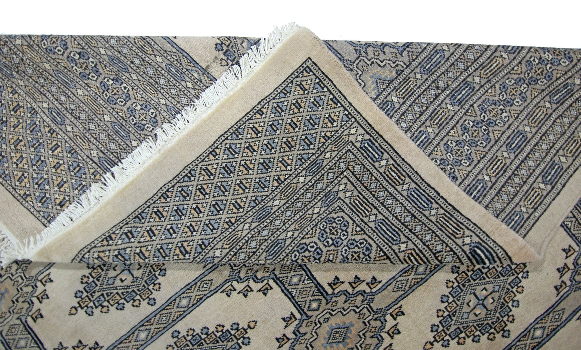 A vintage Pakistani Princess Bokhara rug with a geometric pattern in blue and beige tones.