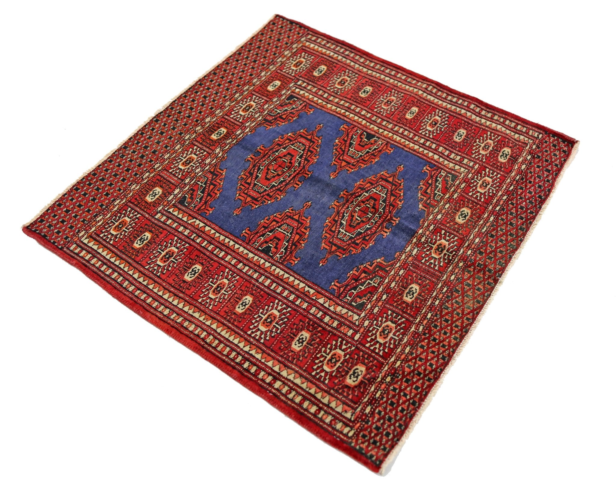 A square vintage Pakistani Princess Bokhara rug featuring a blue field with red geometric motifs.