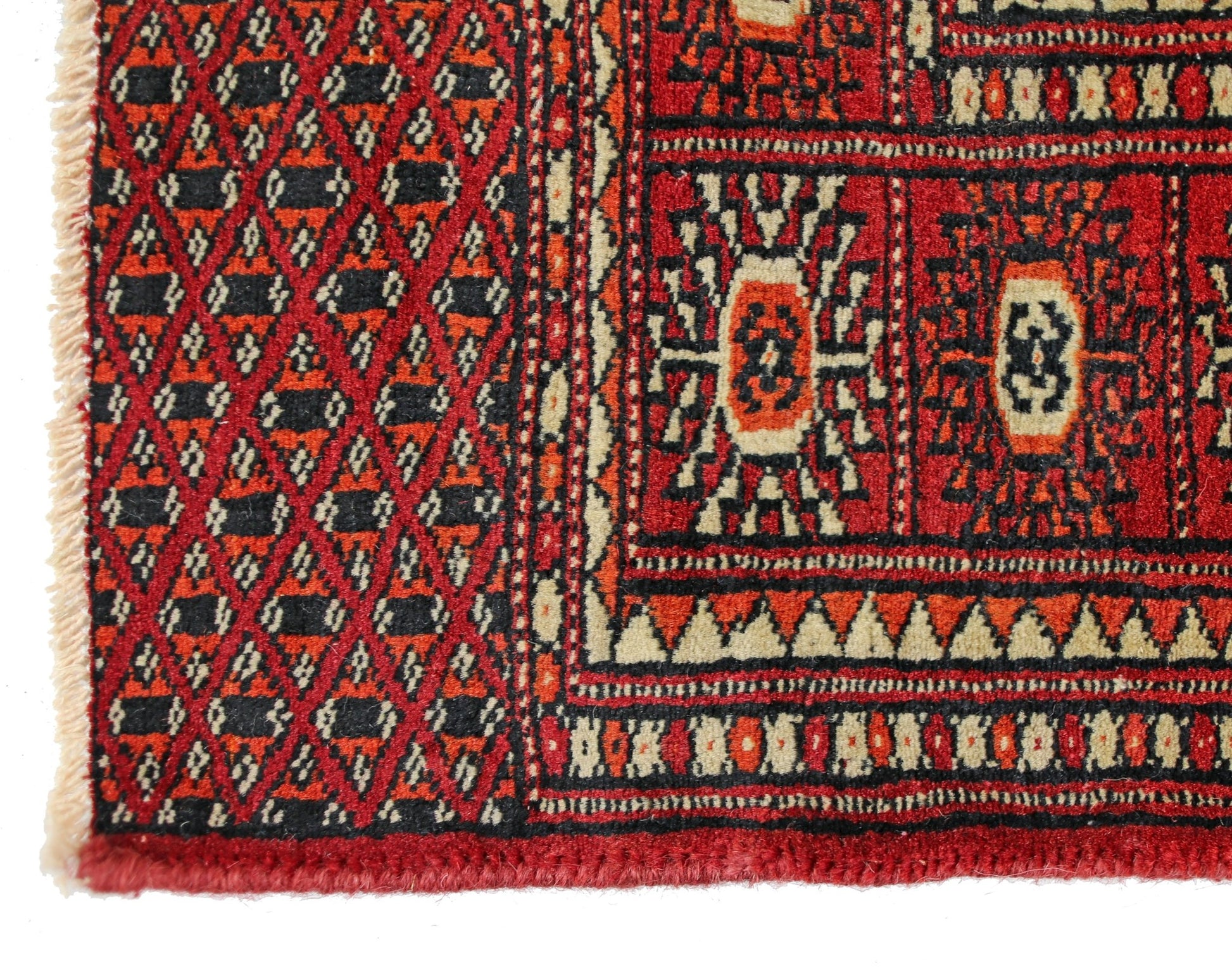 A vintage Pakistani Princess Bokhara rug featuring a geometric diamond pattern in red and black.