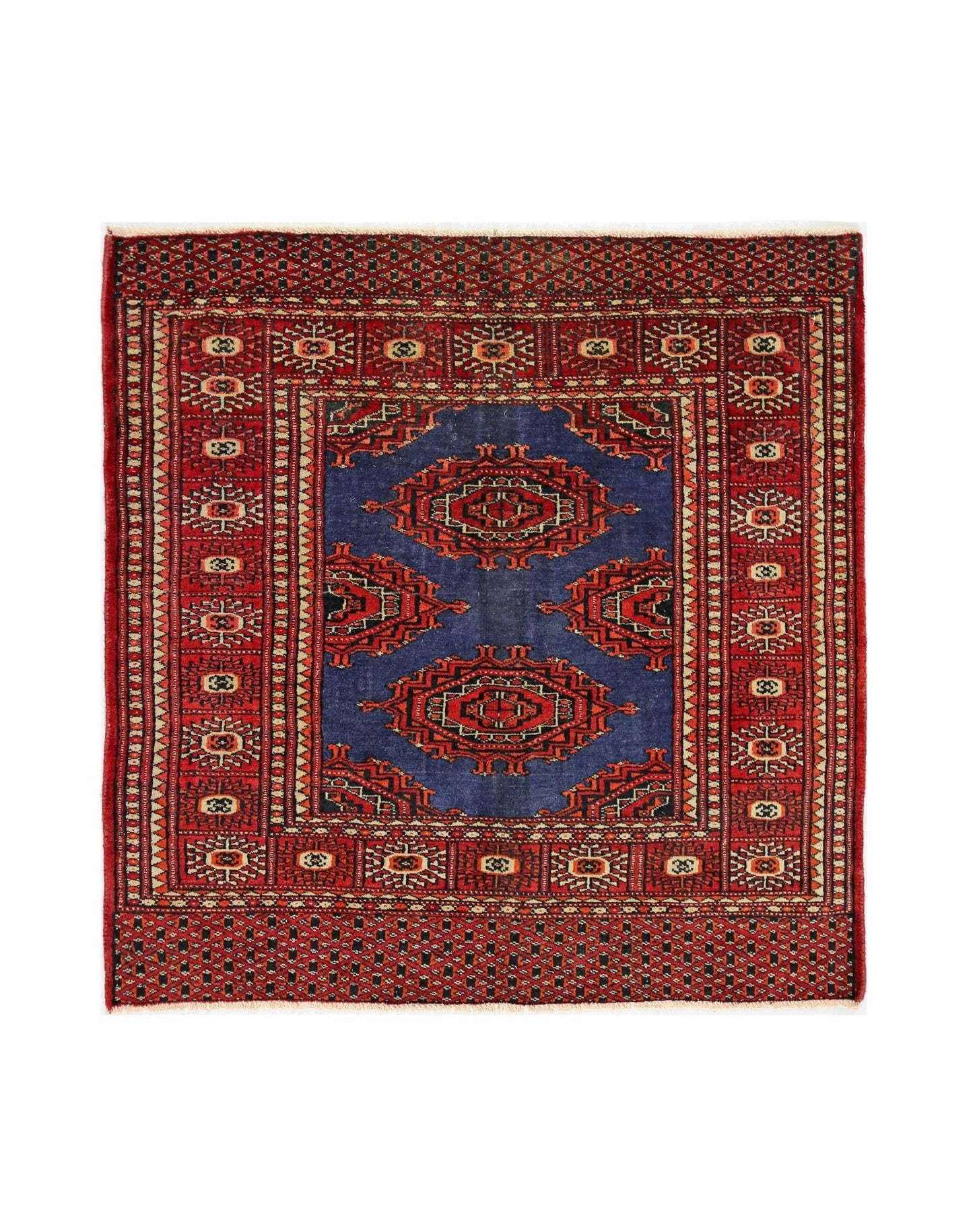 A vintage Pakistani Princess Bokhara rug featuring a blue field with red geometric medallions.