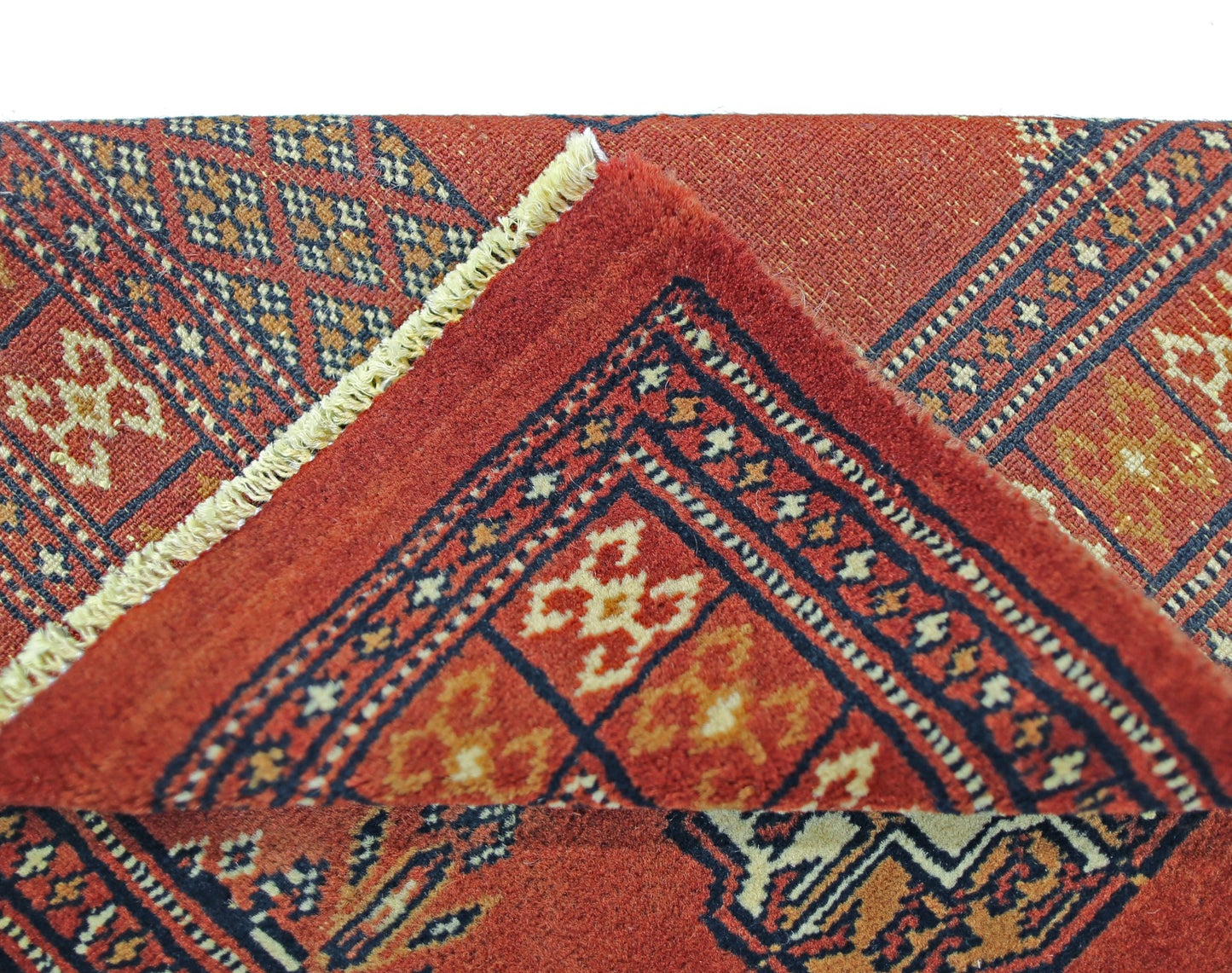 A vintage Pakistani Princess Bokhara runner featuring a geometric red pattern and wool pile.