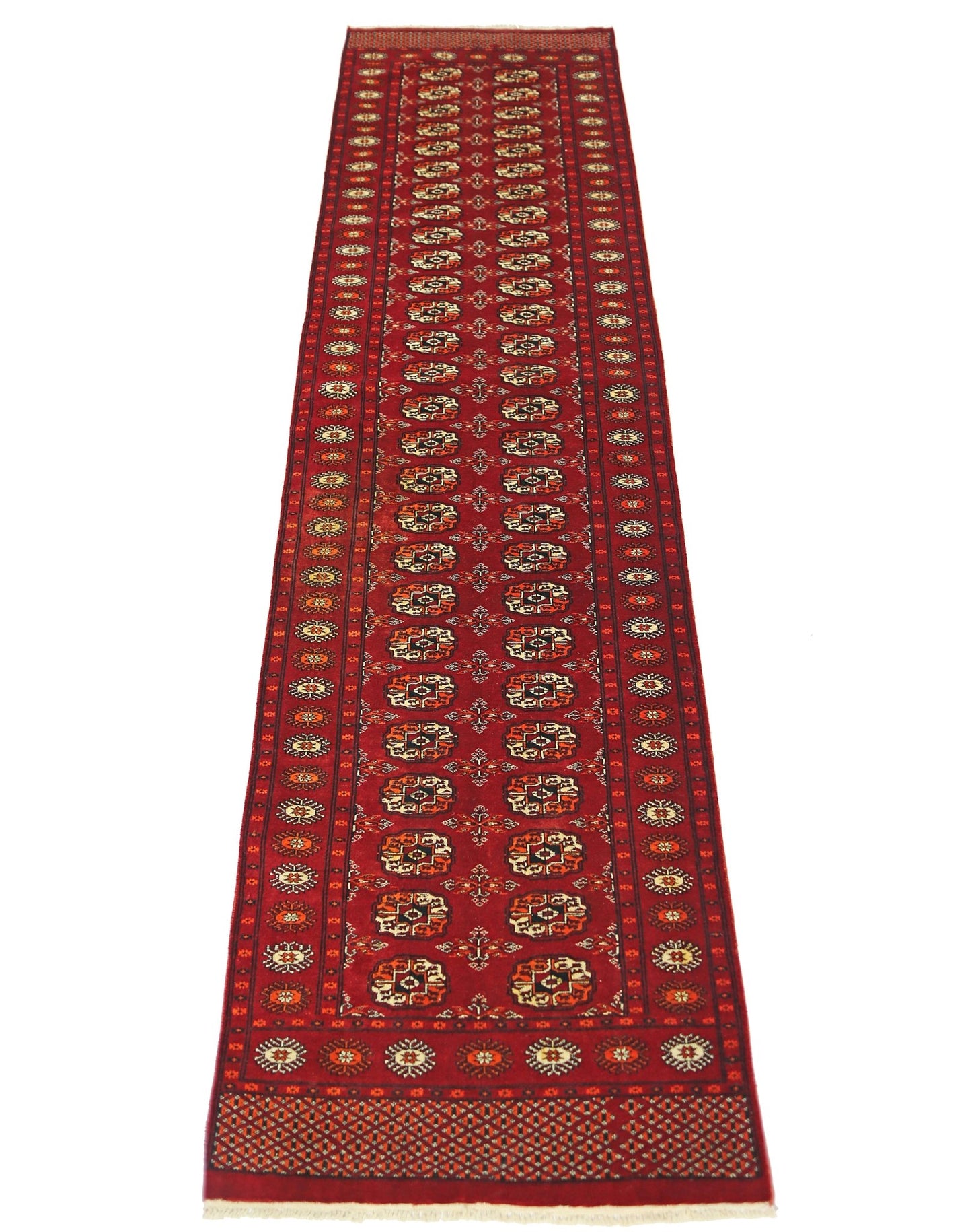 A vintage Pakistani Princess Bokhara runner featuring a repeating geometric pattern in red wool.