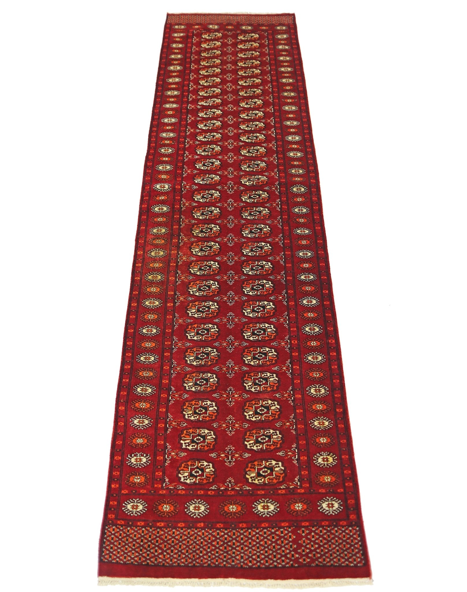 A vintage Pakistani Princess Bokhara runner featuring a repeating geometric pattern in red wool.