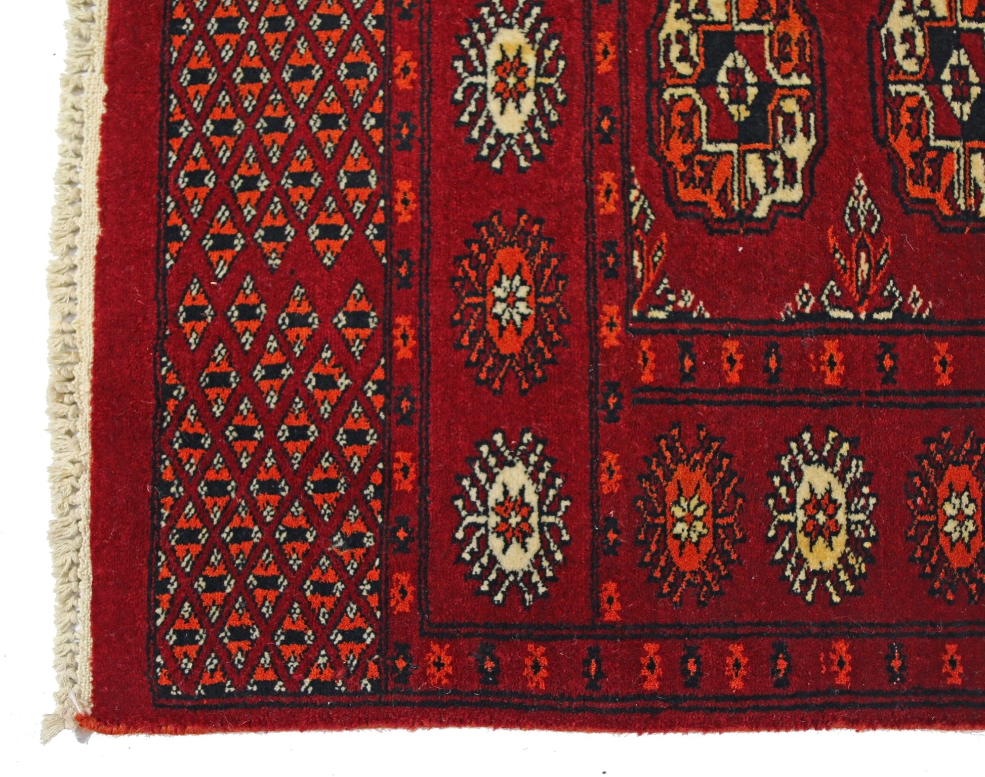 A vintage Pakistani Princess Bokhara runner featuring a red field with geometric patterns and fringe.