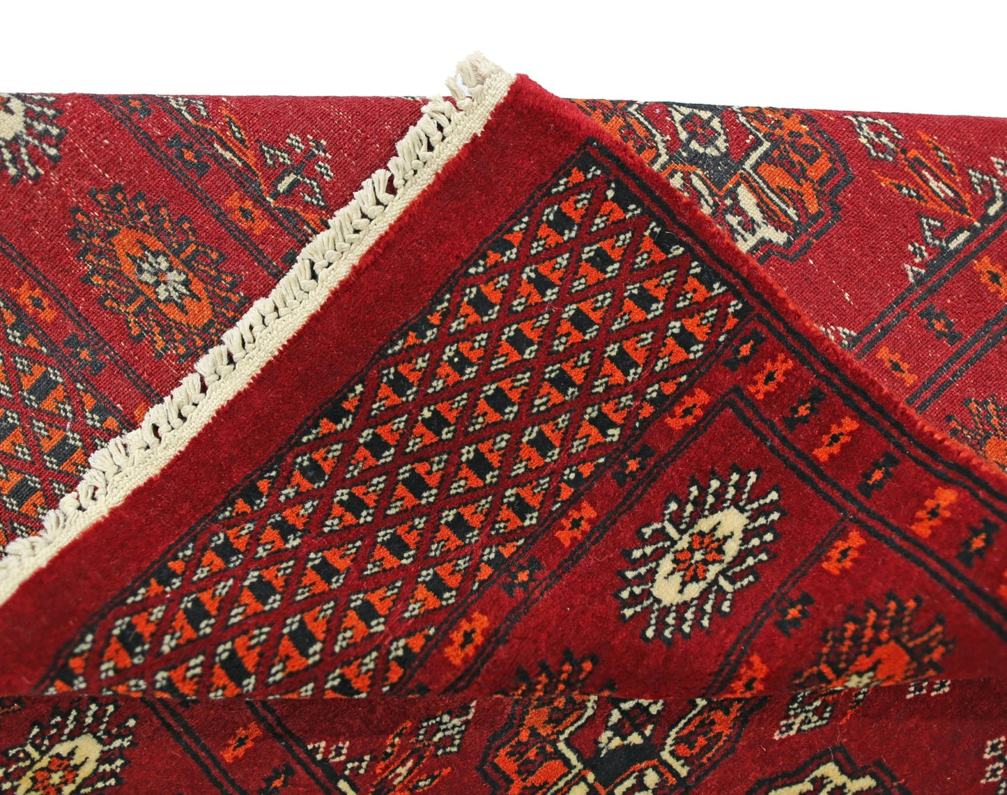 A vintage Pakistani Princess Bokhara runner featuring a red geometric pattern and fringe.
