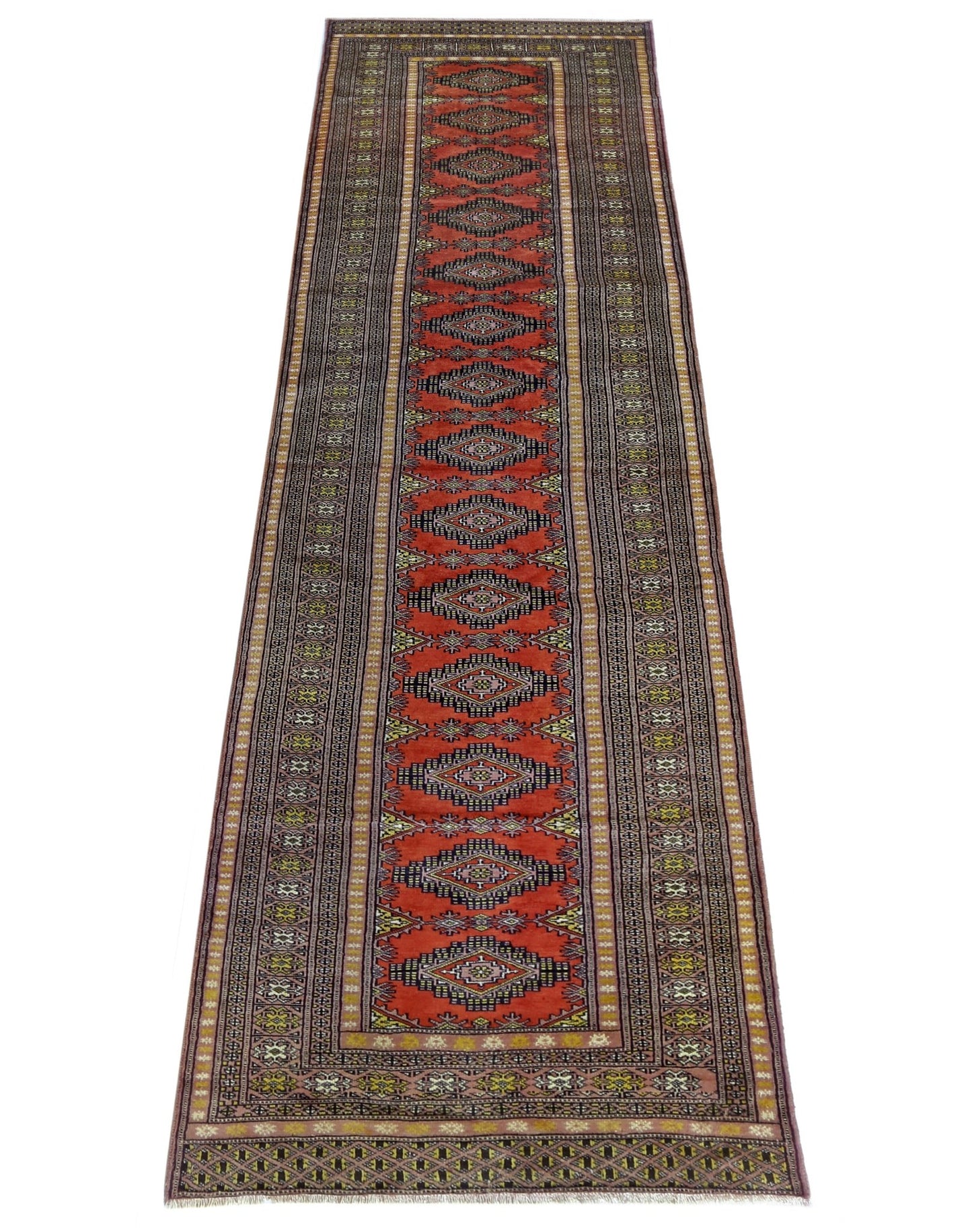 A vintage Pakistani Princess Bokhara runner featuring repeating diamond motifs on a red background.