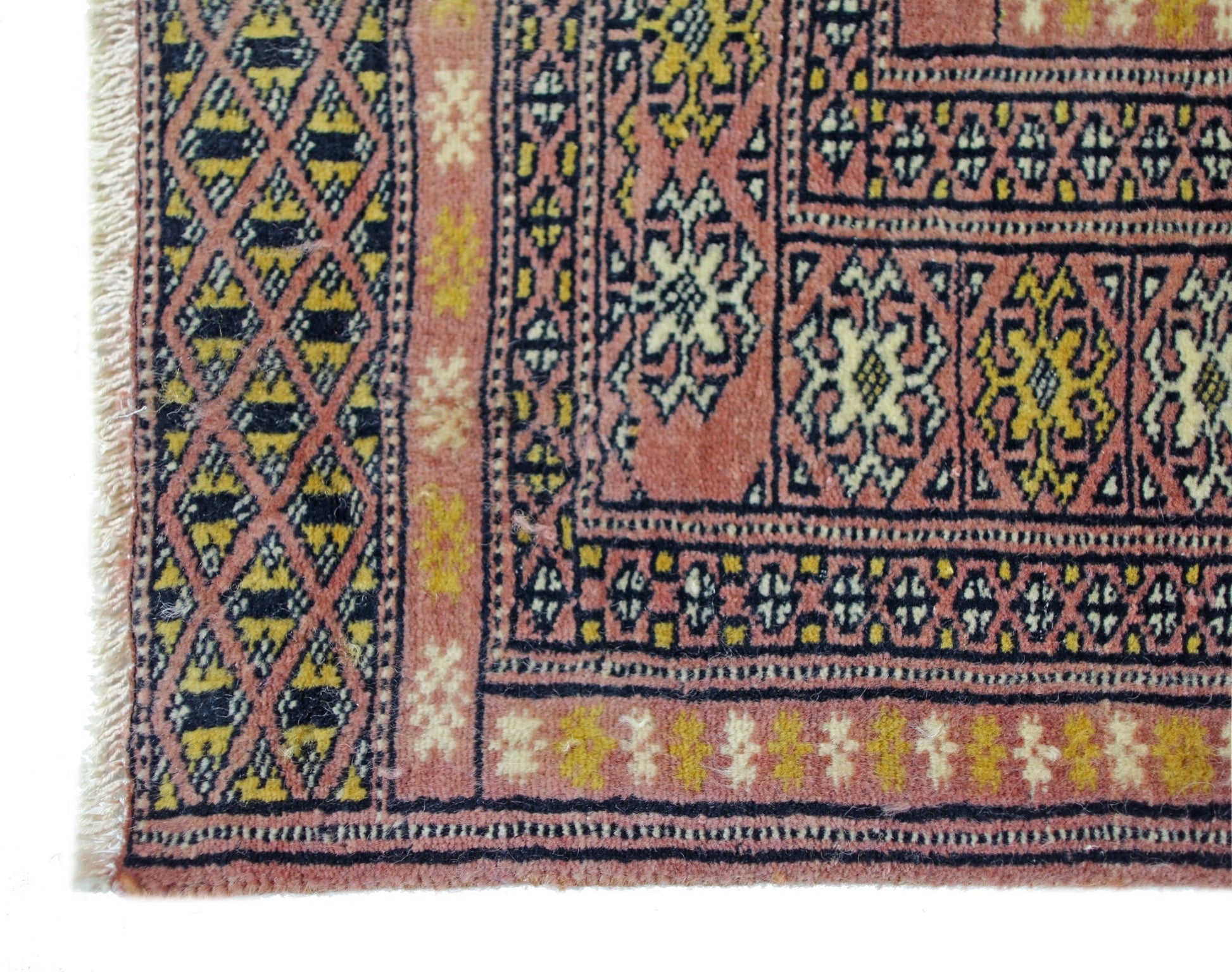 A vintage Pakistani Princess Bokhara runner featuring geometric patterns in pink, yellow, and black.