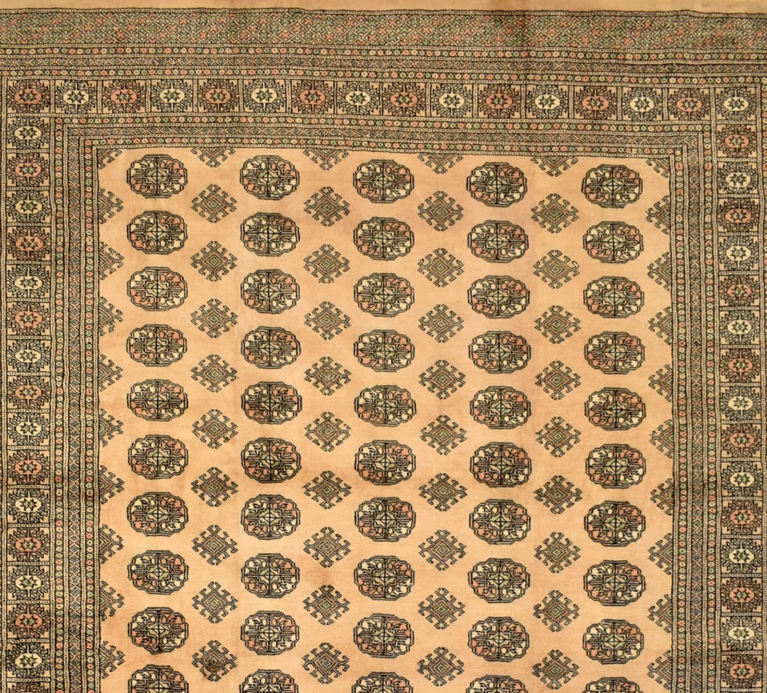 A handmade wool runner rug featuring a repeating pattern of octagonal motifs on a peach background.
