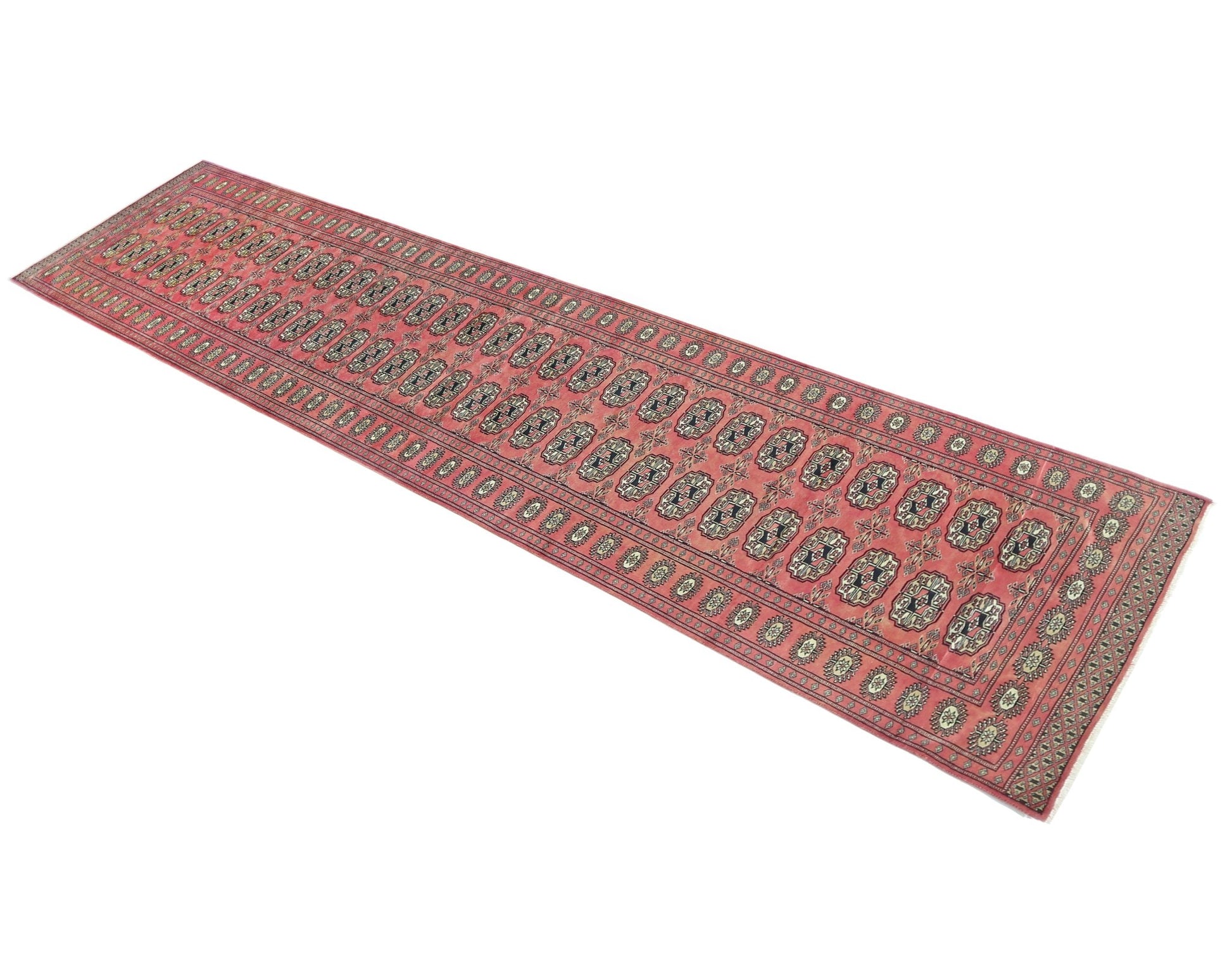 A vintage Pakistani Princess Bokhara runner rug featuring a repeating geometric pattern in red.