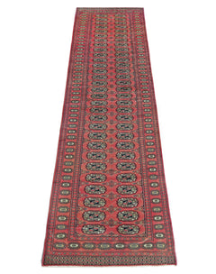 A vintage Pakistani runner rug featuring a repeating geometric pattern in shades of red and black.