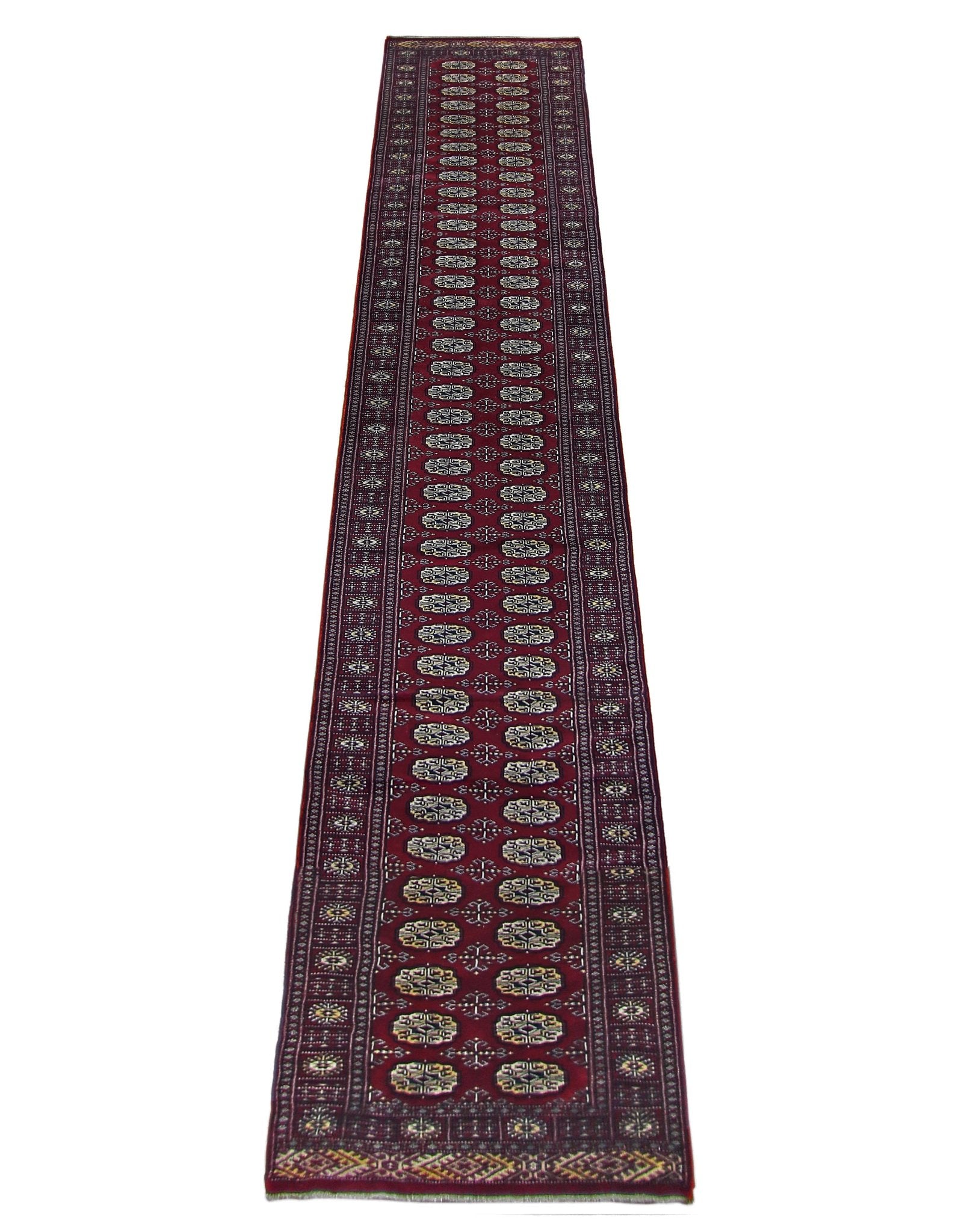 A long, vintage Pakistani Princess Bokhara runner rug featuring a deep red field with repeating geometric motifs.