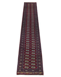 A long, vintage Pakistani Princess Bokhara runner rug featuring a deep red field with repeating geometric motifs.
