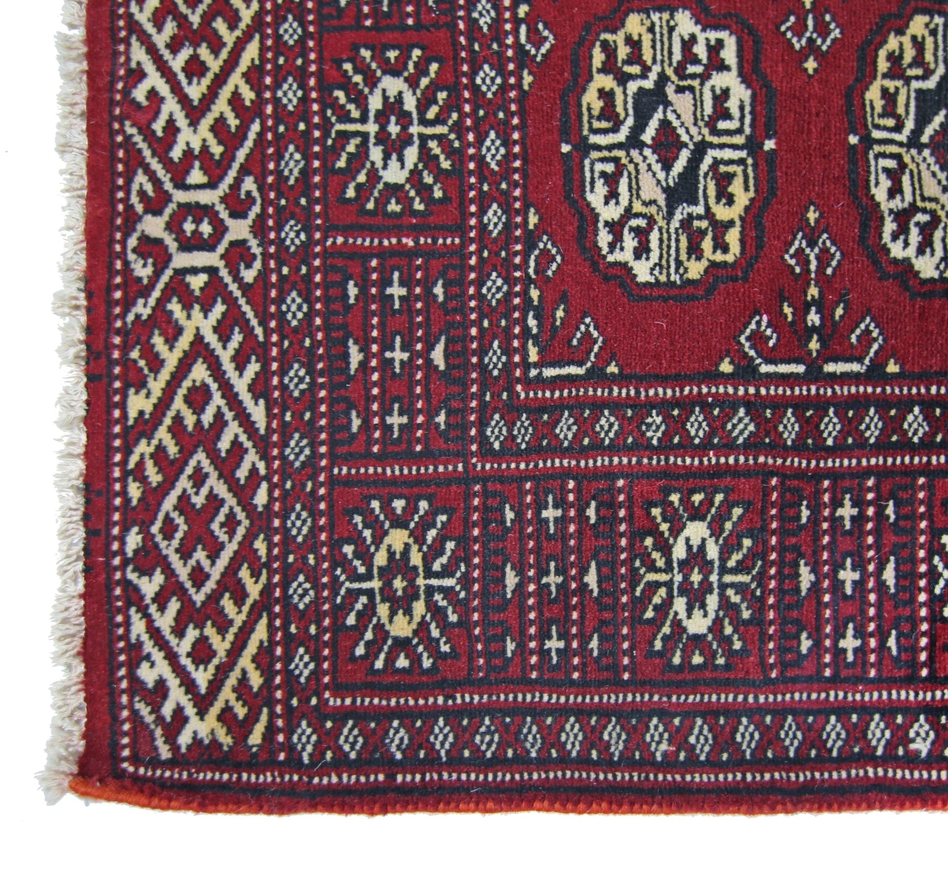 A vintage Pakistani Princess Bokhara runner featuring geometric patterns in red and cream wool.
