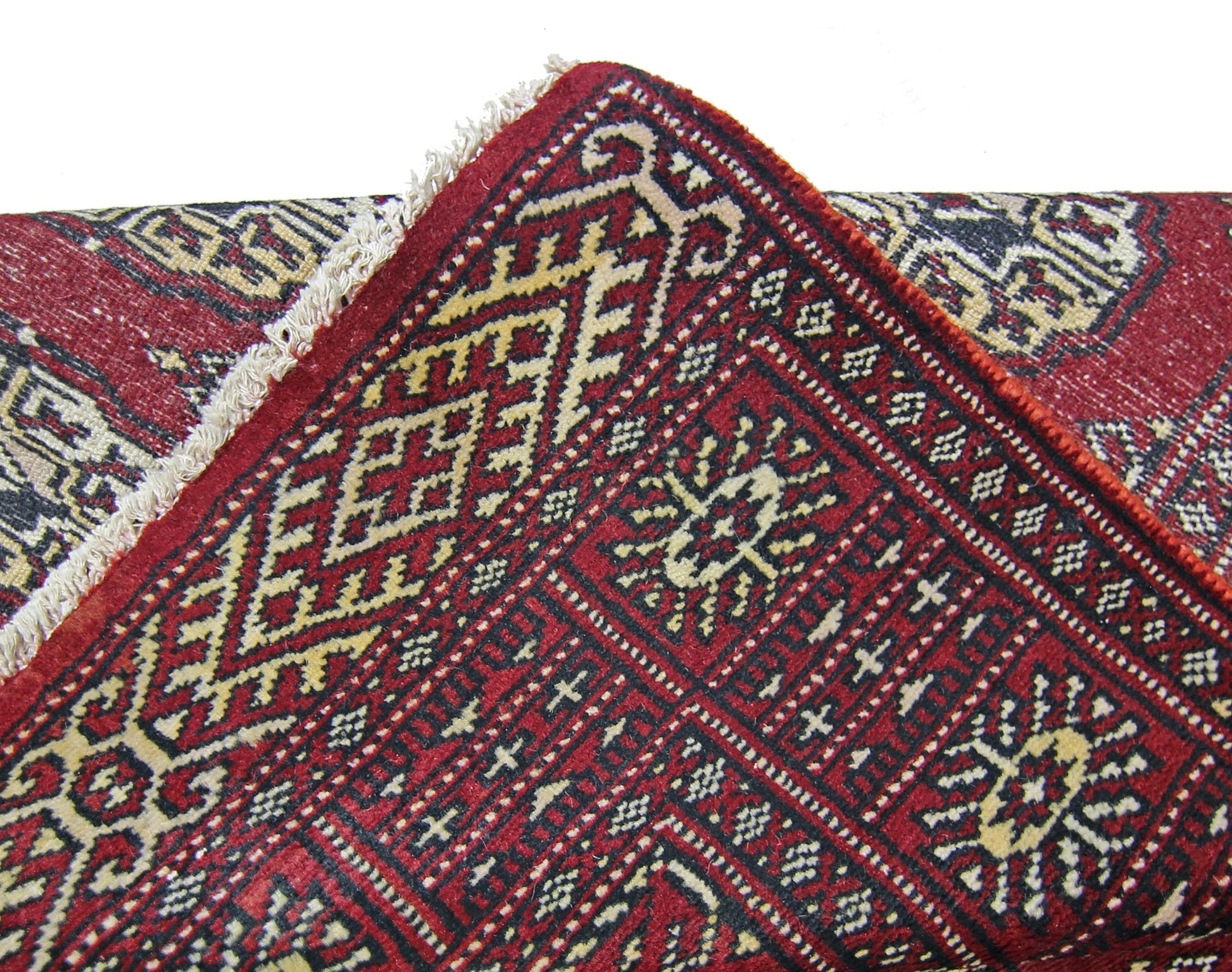 A vintage Pakistani Princess Bokhara runner featuring a geometric red, black, and cream pattern.