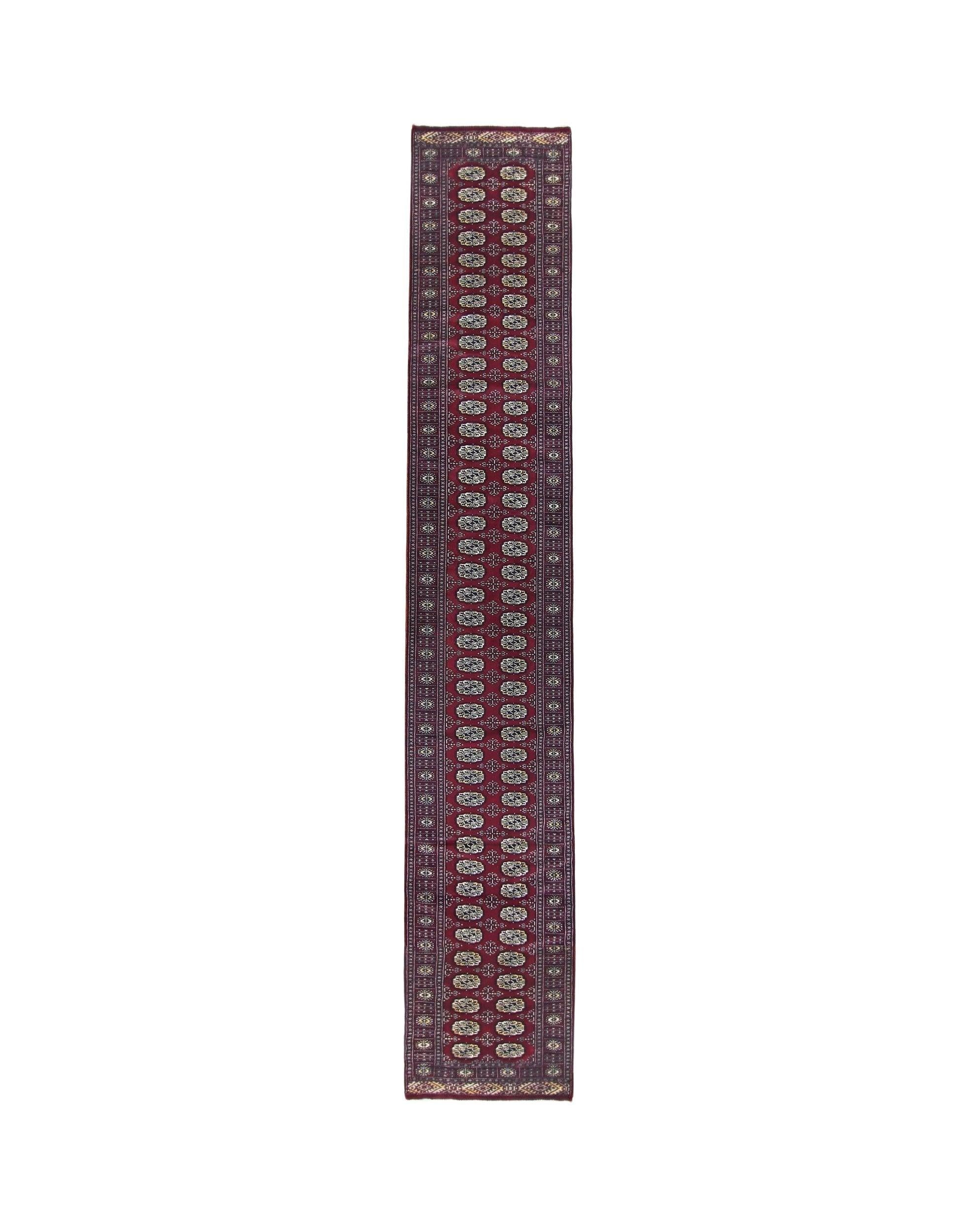 A vintage Pakistani Princess Bokhara runner featuring a deep red field with repeating oval motifs.