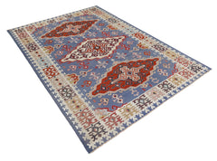 Vintage Serbian Pirot kilim with a blue field, bold red geometric medallions, and intricate folk-inspired border patterns.