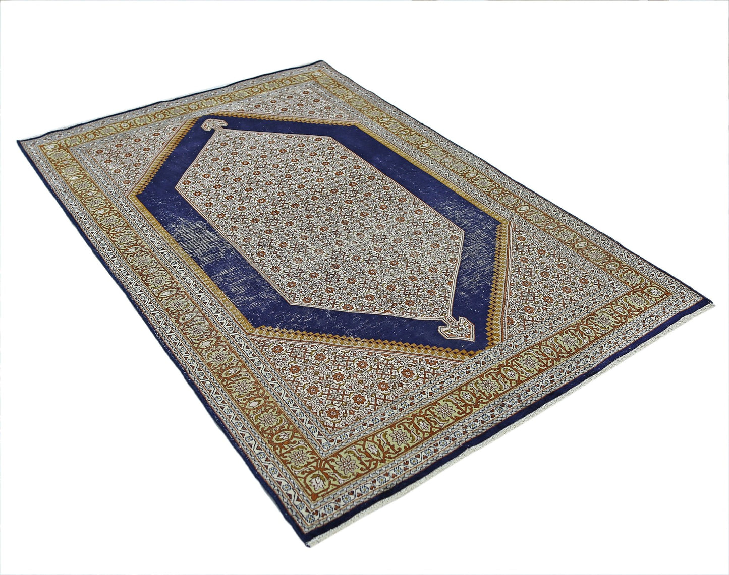 A vintage handmade Kashmiri silk rug featuring a central hexagonal medallion on a blue field.