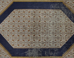 A vintage Kashmiri silk rug featuring a central floral lattice pattern on a dark blue background.