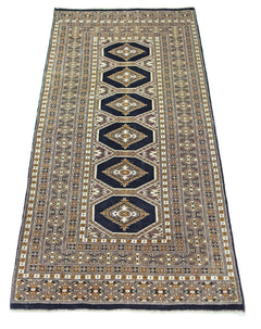A vintage Pakistani Princess Bokhara runner rug featuring repeating geometric medallions in dark blue.