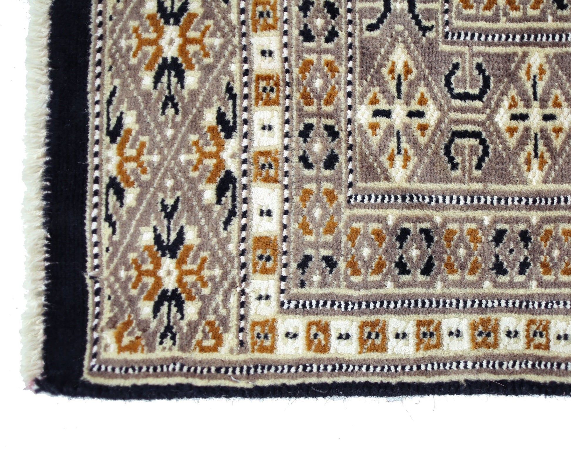 A vintage Pakistani Princess Bokhara rug featuring intricate geometric patterns in brown, cream, and black.