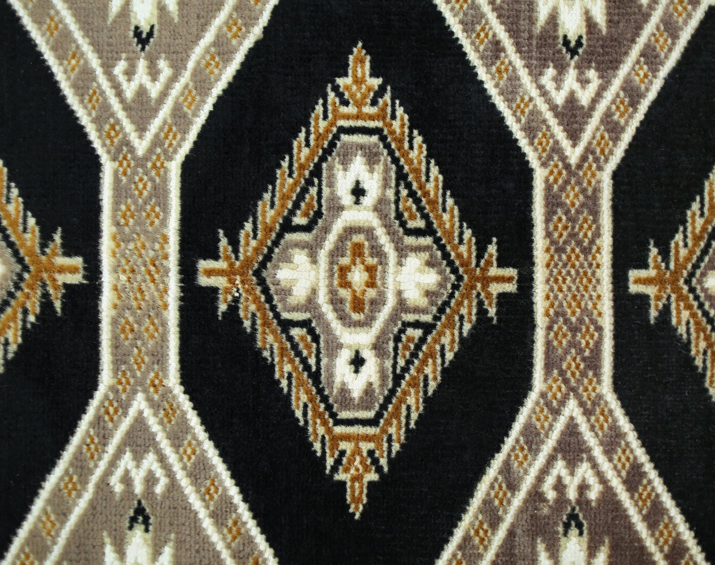 A vintage Pakistani Princess Bokhara rug featuring a repeating geometric diamond pattern in black, brown, and cream.