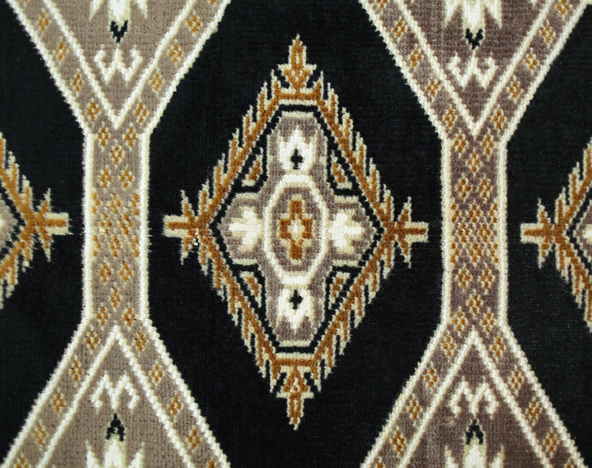 A vintage Pakistani Princess Bokhara rug featuring a repeating geometric diamond pattern in black, brown, and cream.