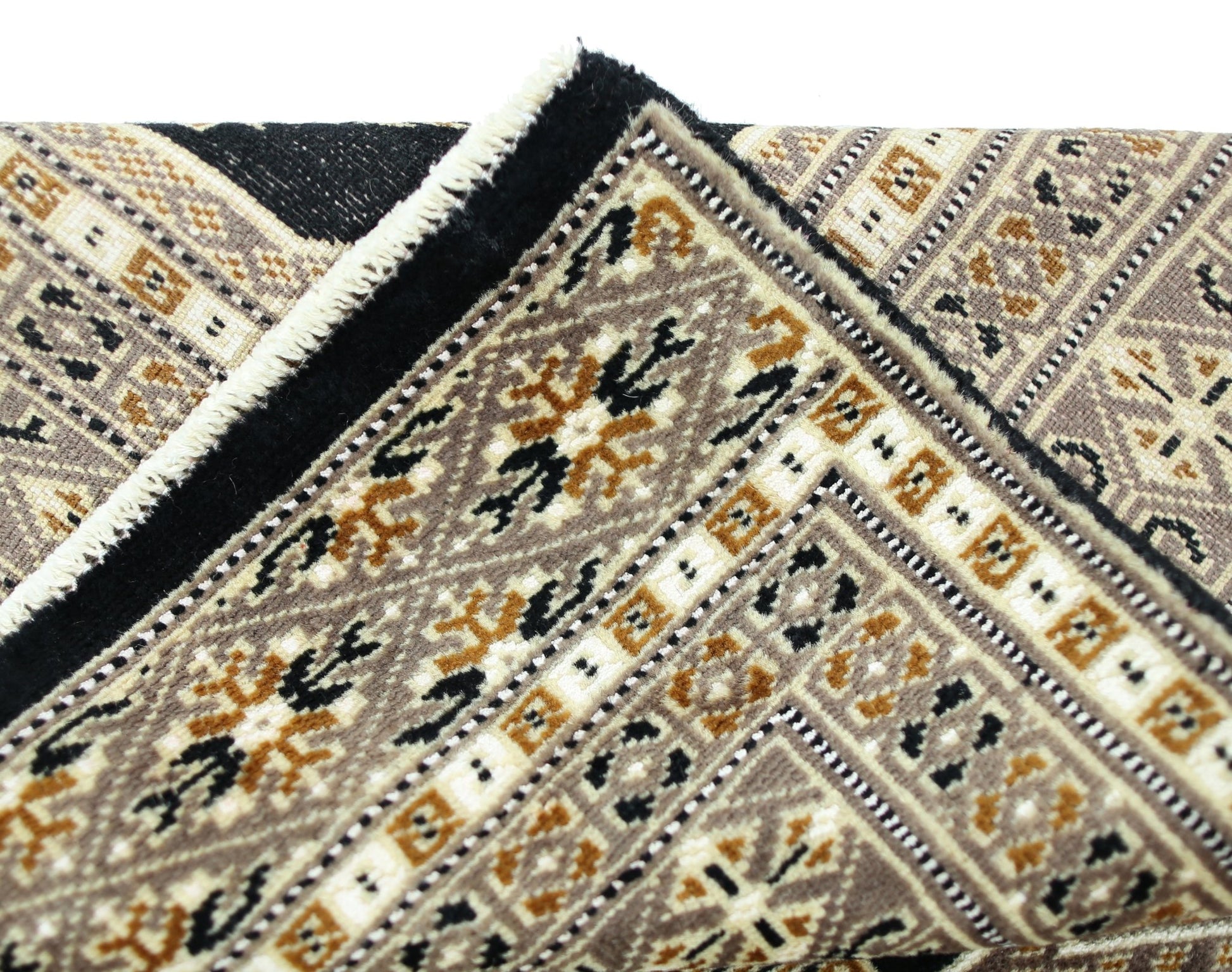 A vintage Pakistani Princess Bokhara rug featuring intricate geometric patterns in brown and black.