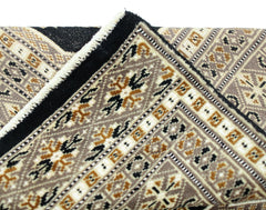 A vintage Pakistani Princess Bokhara rug featuring intricate geometric patterns in brown and black.