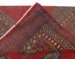 A vintage Pakistani Princess Bokhara rug featuring a red field with intricate geometric patterns.