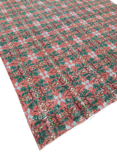 A vintage handmade Turkish wool rug featuring a repeating geometric pattern in red and green.