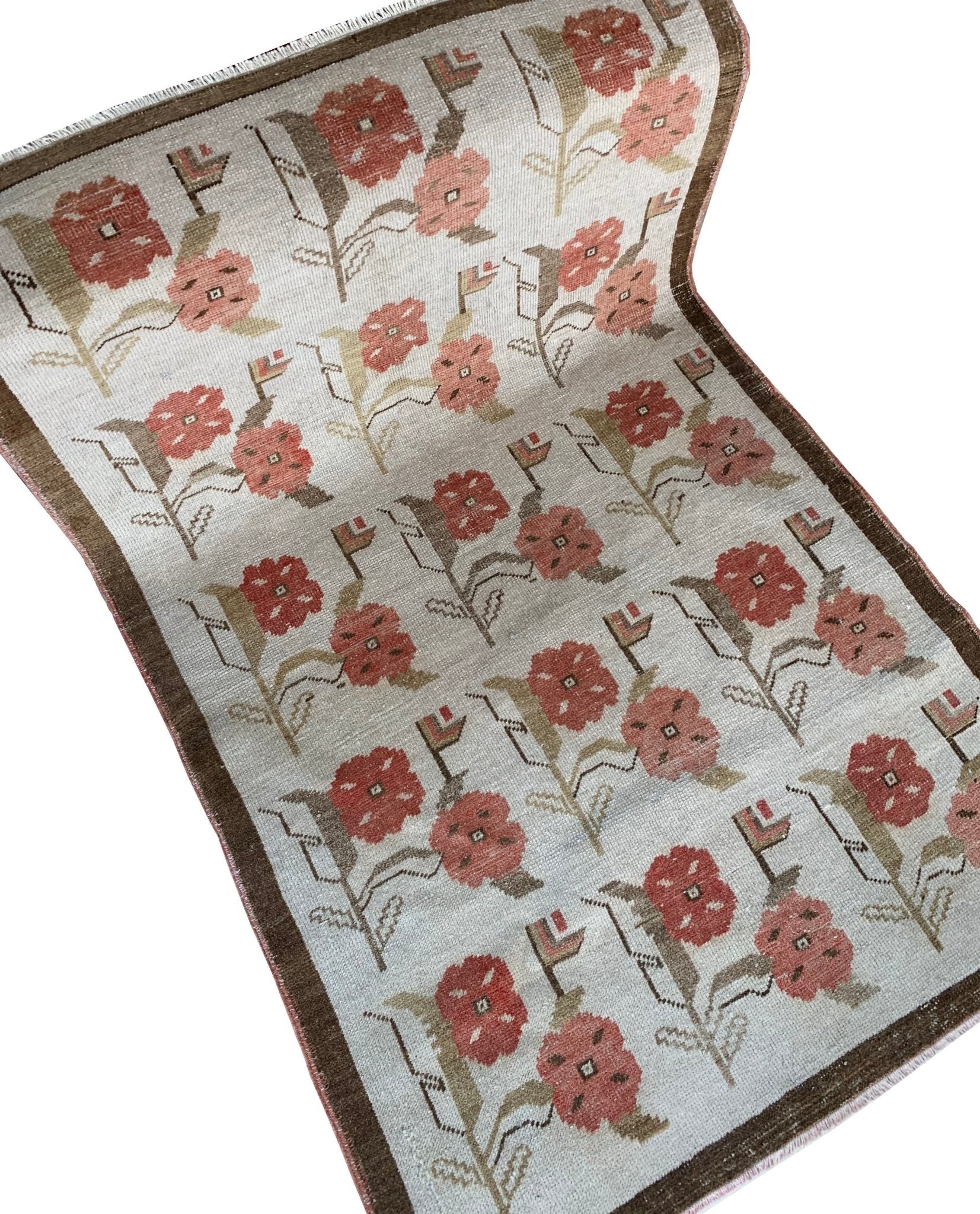A vintage Turkish Oushak rug featuring a repeating floral tulip pattern in muted red and brown.