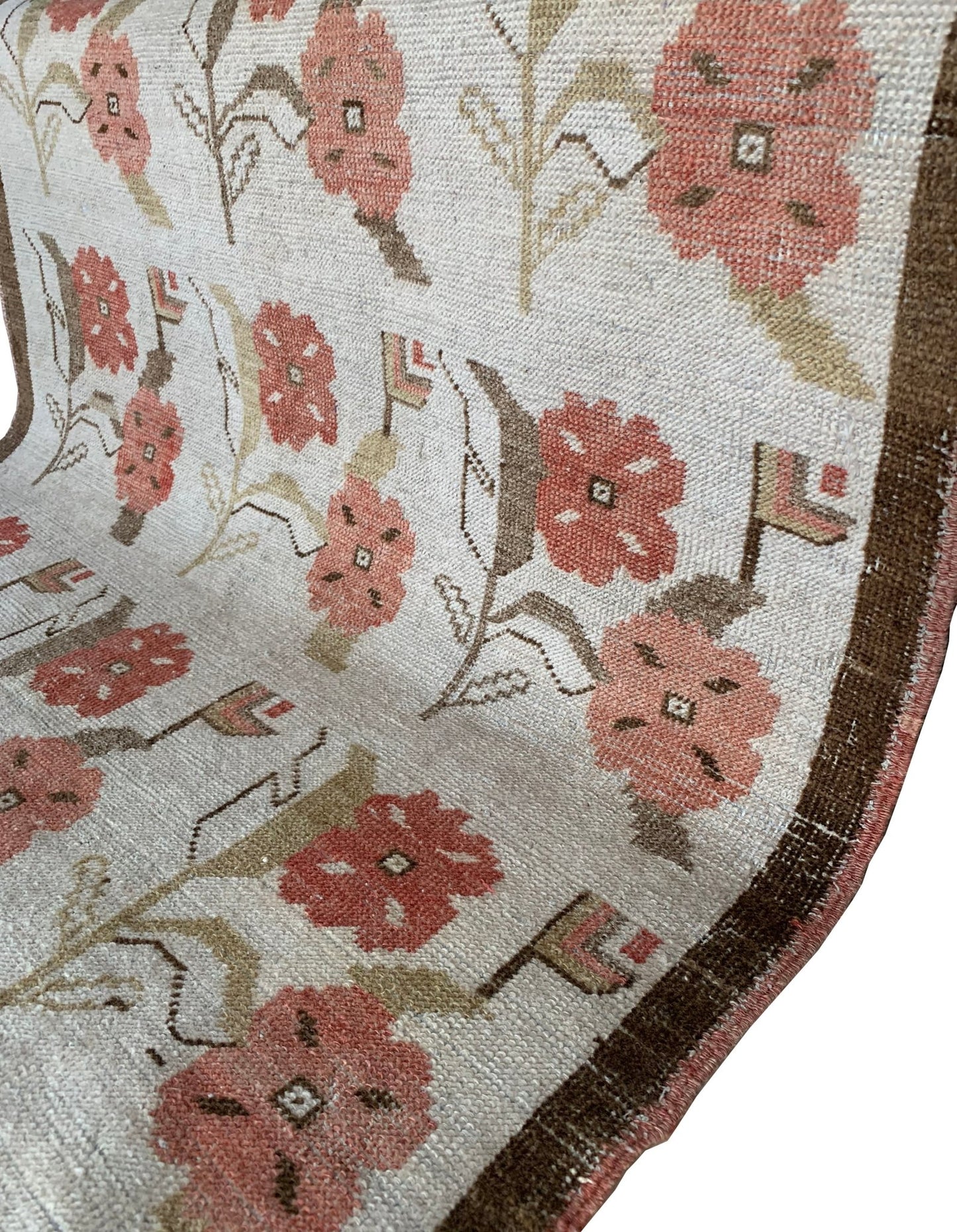 A vintage Turkish Oushak rug featuring a cream background with a pink floral tulip pattern.