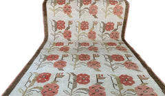 A vintage Turkish Oushak runner rug featuring a repeating floral tulip pattern in muted tones.