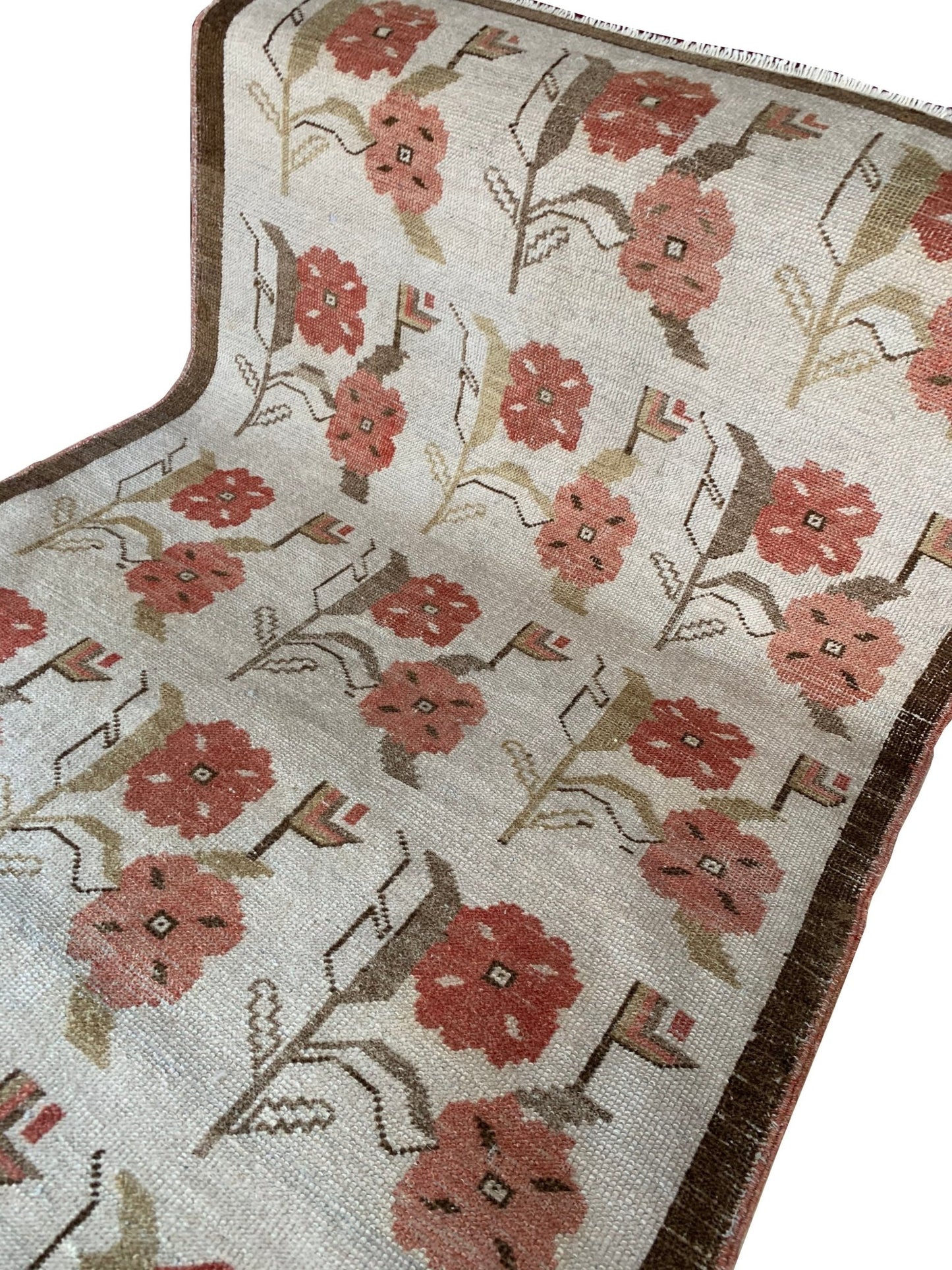 Vintage Turkish Oushak rug featuring a floral tulip pattern in muted pink and brown tones.