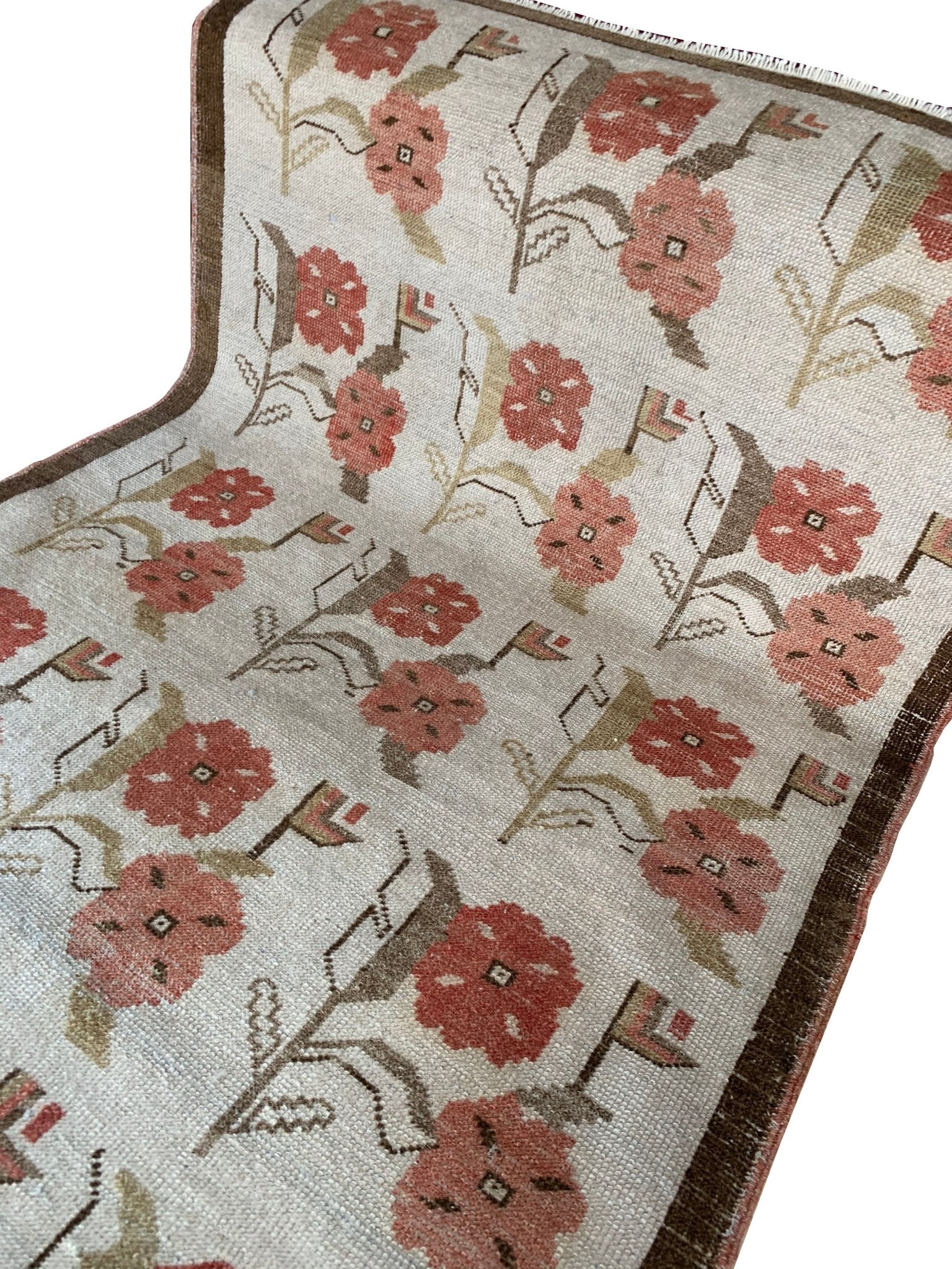 Vintage Turkish Oushak rug featuring a floral tulip pattern in muted pink and brown tones.