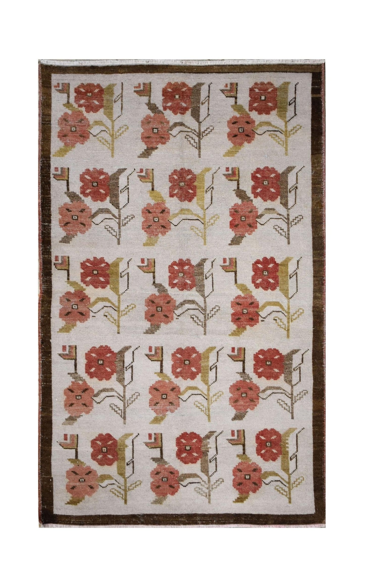 A vintage Turkish Oushak rug featuring a repeating floral tulip pattern in muted earth tones.